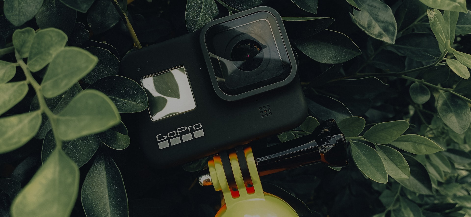 a camera sitting on top of a yellow fire hydrant